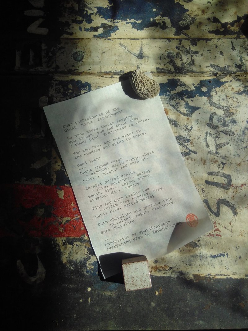 Printed menu on an old metal box, weighted down by a porous stone and a ceramic cube.